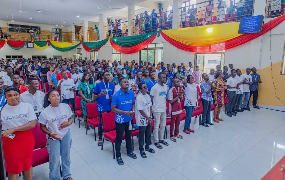 A view from the podium showing the vibrant participation of youth in the main auditorium