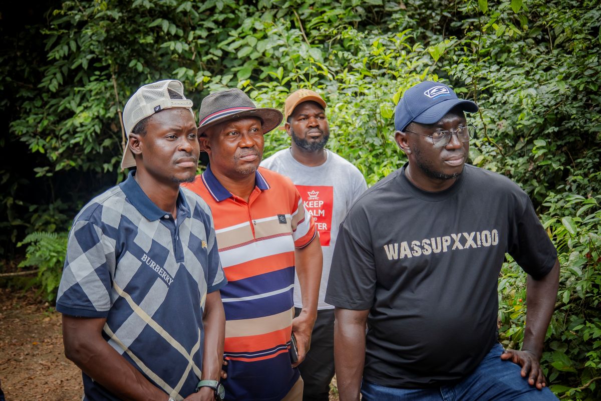 Ranger explaining tree species to Gambian parliamentarians