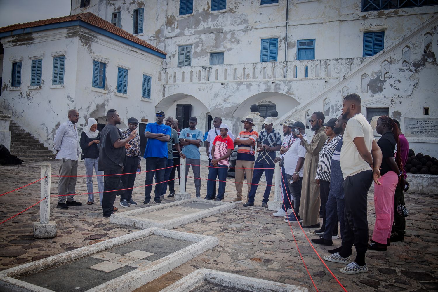 Group at Cape Coast Castle entrance with guide